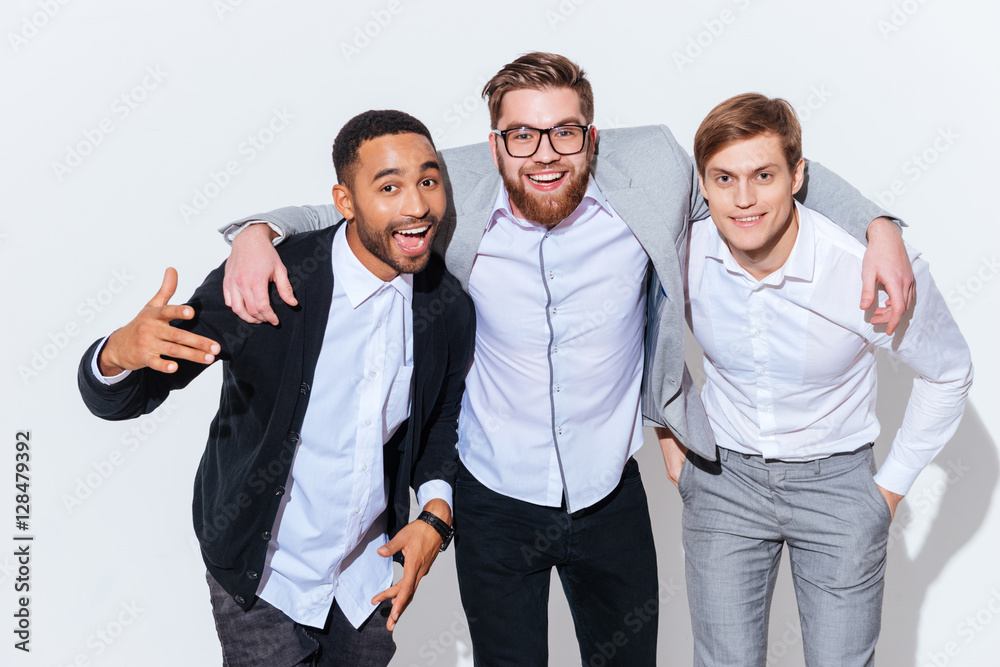 Portrait of three happy handsome young men standing together Portrait of three happy handsome young men standing together