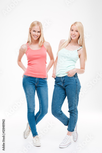 Young ladies dressed in t-shirts and jeans posing