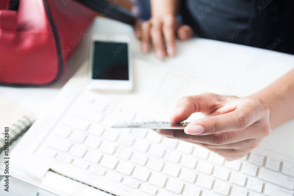 Hands holding credit card and using laptop. Online shopping Hands holding credit card and using laptop. Online shopping