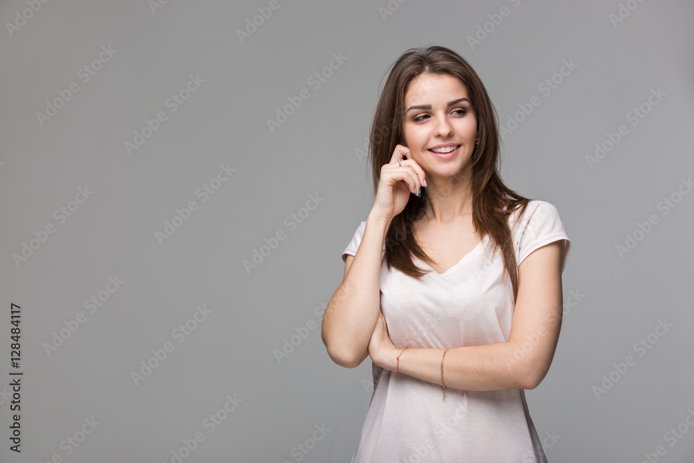 Portrait of beautiful brunette woman with natural make-up, on grey background Portrait of beautiful brunette woman with natural make-up, on grey background