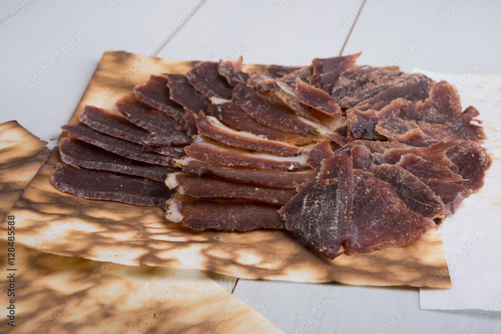 Jerky meat sliced on wooden board