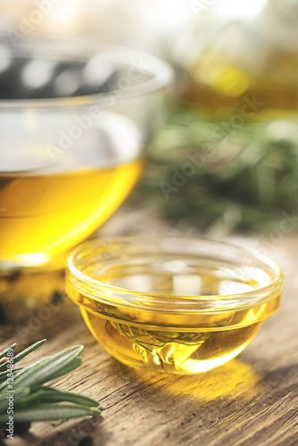 Olive oil  in the glass bowl on wooden table  vertical © deniskarpenkov