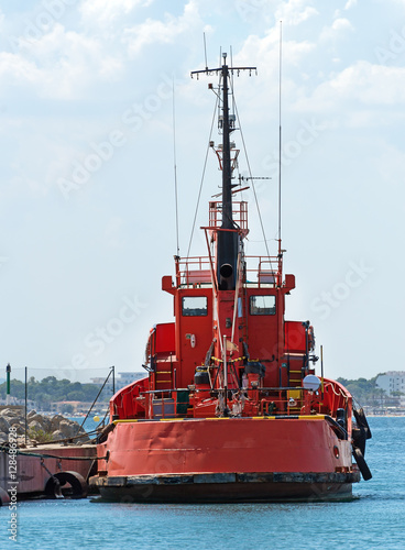 Red tugboat in the port.