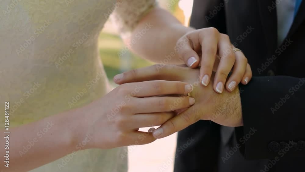 The beautiful bride wears the groom's ring. Wedding ceremony