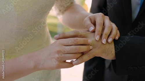 The beautiful bride wears the groom's ring. Wedding ceremony