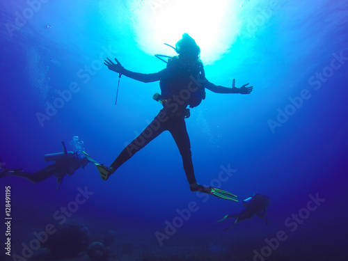 Underwater scuba diving selfie shot with selfie stick. Deep blue sea. Wide angle shot. © tirachard