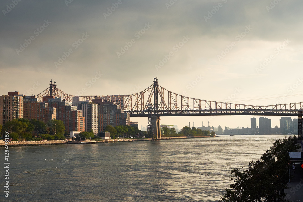 A view down East River from north with Queensboro bridge and the housing on Roosevelt Island in the foreground