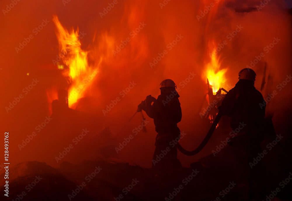 Obraz premium Firefighters extinguish a house