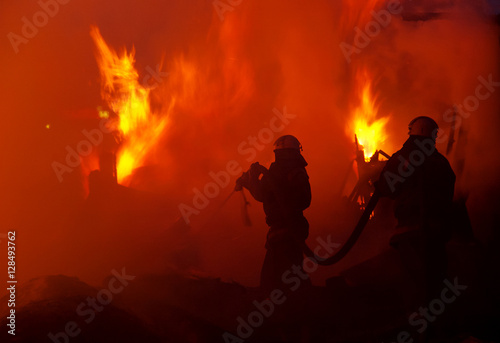 Firefighters extinguish a house