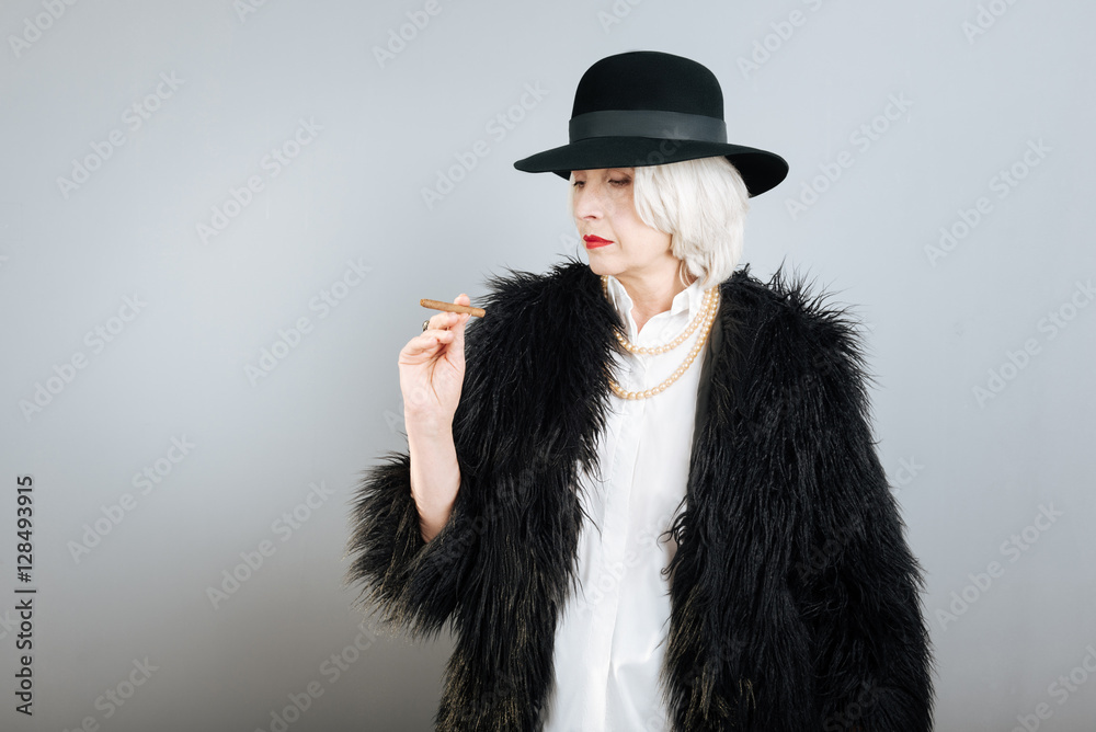 Quiet senior woman smoking cigarette. Quiet senior woman smoking cigarette.