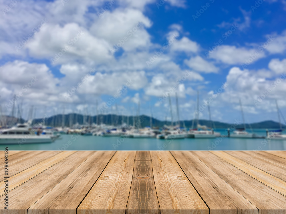 Wooden board empty table in front of blurred background. Perspective brown wood table over blur boat in port background - can be used mock up for display or montage your products. summer season.