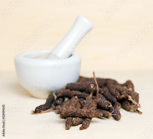 Long pepper or Pipli or Dipli (Piper longum) isolated on wood ba photo