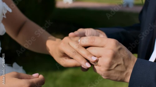 Happy the groom puts ring the beautiful bride