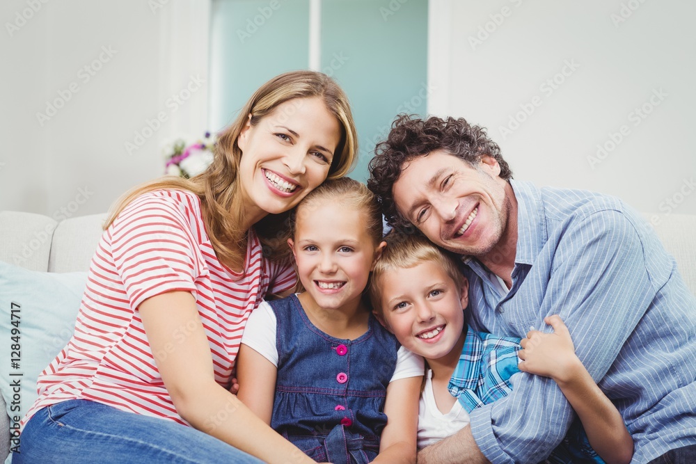 Happy family sitting on sofa at home