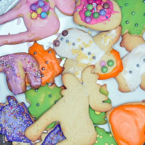 Colorful cookies with icing on a baking sheet