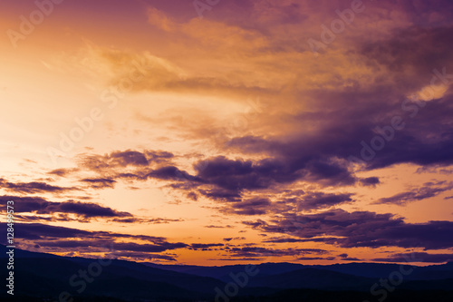 Soft focus winter sunset high up in the silhouette mountains © jes2uphoto