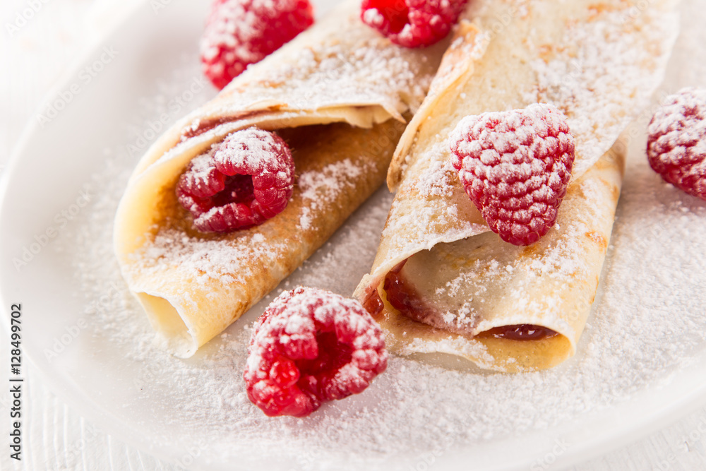 Pancakes with berries and maple syrup