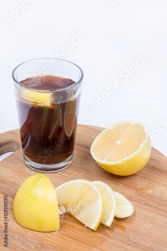 Juice with sliced lemons on the wooden board