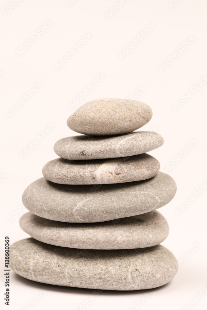 Balanced grey stones over white background with copy space Balanced grey stones over white background with copy space