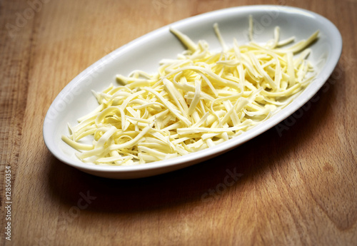 grated hard cheese on a white plate