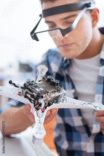 Young man soldering the drone part