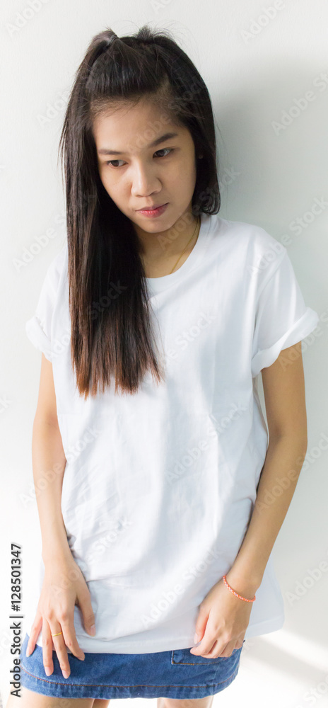 Portrait of young woman on white concrete wall Portrait of young woman on white concrete wall