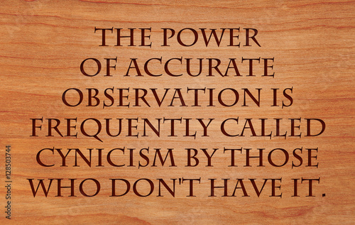 The power of accurate observation is frequently called cynicism by those who don't have it  - quote on wooden red oak background.