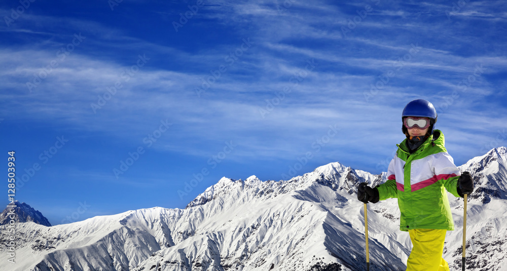Young skier with on snow mountains at sun winter day Young skier with on snow mountains at sun winter day