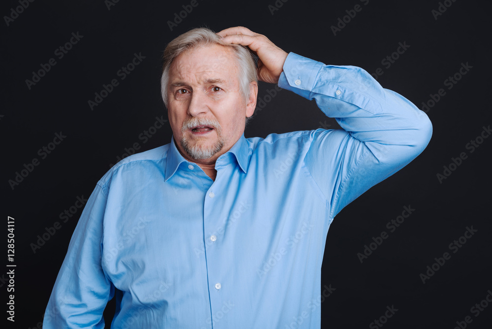 Elderly man looking disturbed