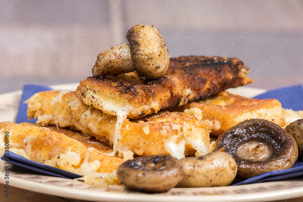 Fried mushroom with fried yellow cheese on eggs Fried mushroom with fried yellow cheese on eggs
