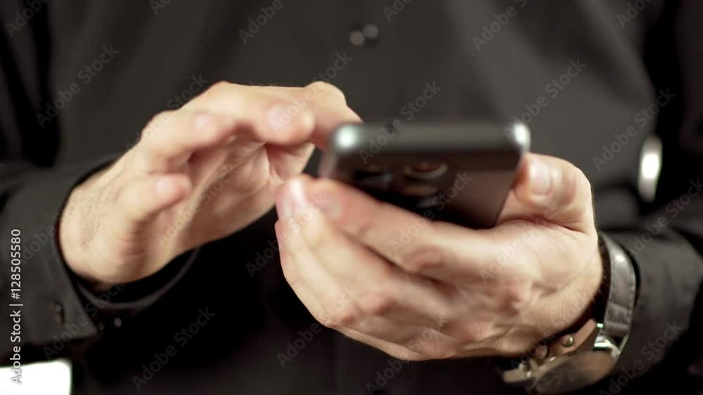 Man's hands swipe to text on an cellphone Man's hands swipe to text on an cellphone
