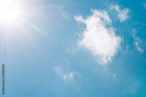 Realistic shining sun with lens flare on blue sky clouds nature day sky background