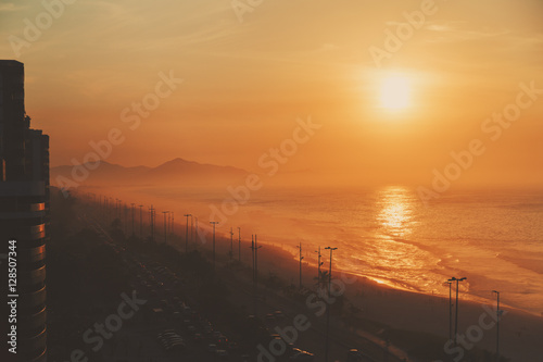 Top view of the ocean, beach, coastline, road and far hills, dramatic and colorful evening, Rio de Janeiro, Brazil © skyNext