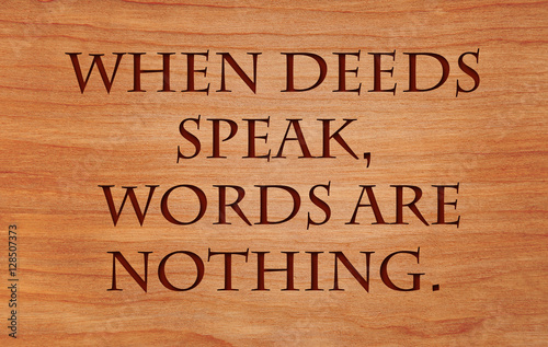When deeds speak, words are nothing - motivational African Proverb on wooden red oak background