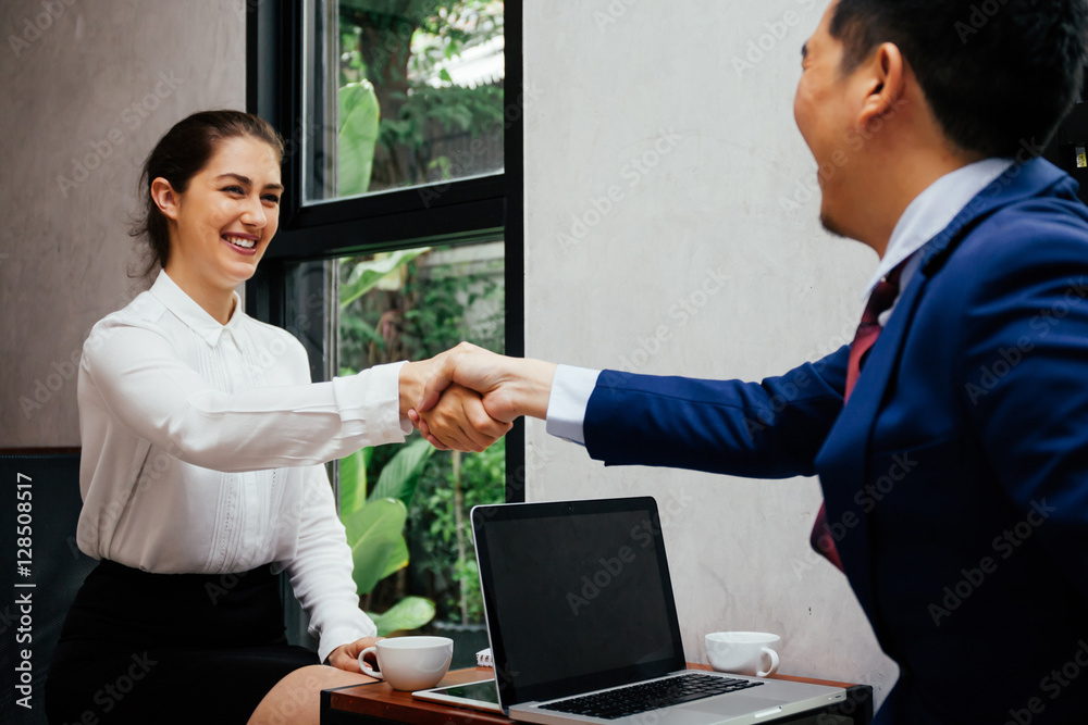 Business woman shaking hands with business man in the modern interior office - Business and partnership concept Business woman shaking hands with business man in the modern interior office - Business and partnership concept