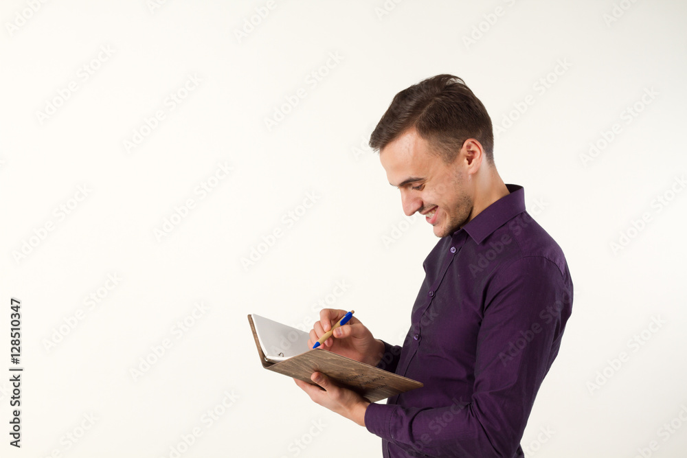 Man writes a pen on a sheet. In the book. Man writes a pen on a sheet. In the book.