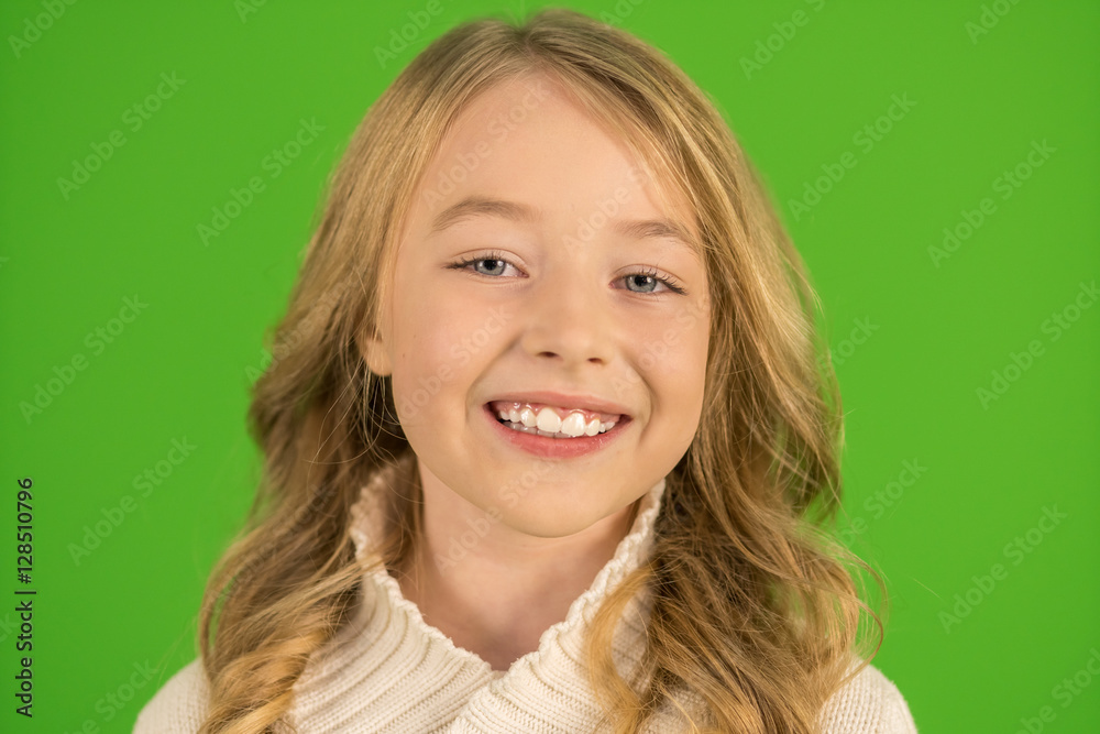 The cute girl smile on the green background. Portrait view The cute girl smile on the green background. Portrait view