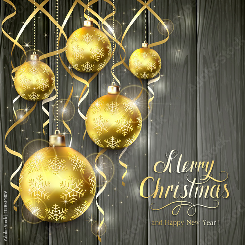 Golden Christmas balls and tinsel on black wooden background