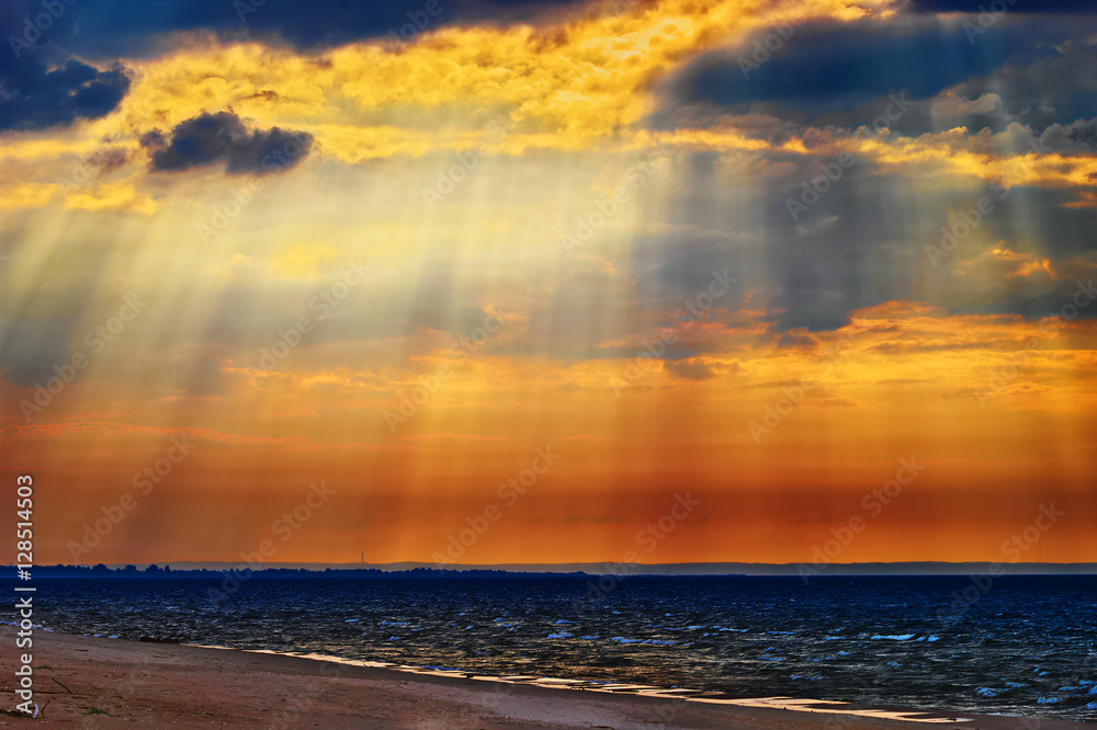 Obraz premium Cloudscape with crepuscular rays or sunbeams over the Baltic sea. Stegna, Pomerania, northern Poland.