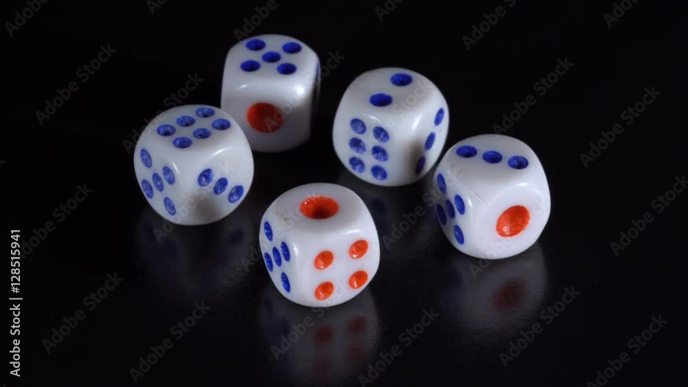 White dice rotate on a black table White dice rotate on a black table