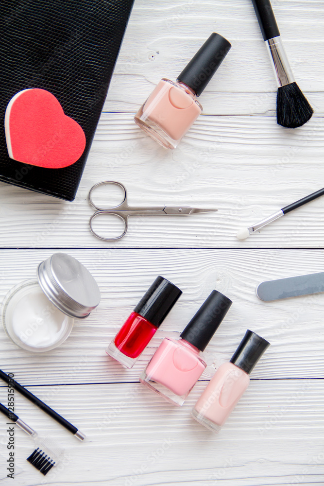 manicure set and nail polish on wooden background manicure set and nail polish on wooden background