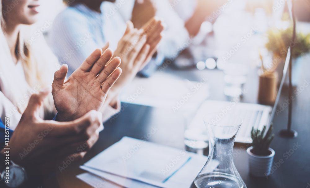 Close up view of business seminar listeners clapping hands. Professional education, work meeting, presentation or coaching concept.Horizontal,blurred background.
