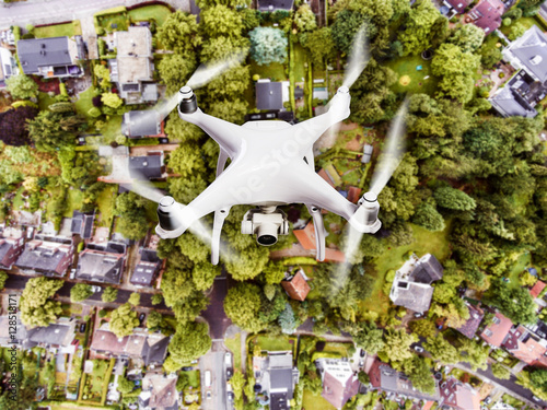 Hovering drone taking pictures of Dutch town. Aerial view. photo