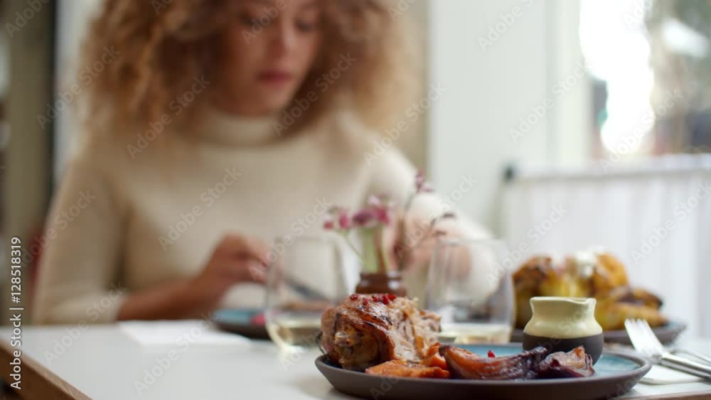 Close Up Of Food As Woman Enjoys Meal In Restaurant Close Up Of Food As Woman Enjoys Meal In Restaurant