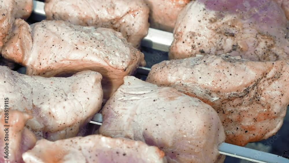 Barbecue skewers with meat cooking on the grill outdoors with smoke. Closeup detailed pan shot. Barbecue skewers with meat cooking on the grill outdoors with smoke. Closeup detailed pan shot.