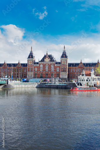 cityscape with central railway station and old town canal in Amsterdam, Holland