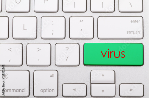 Virus word written on computer keyboard.