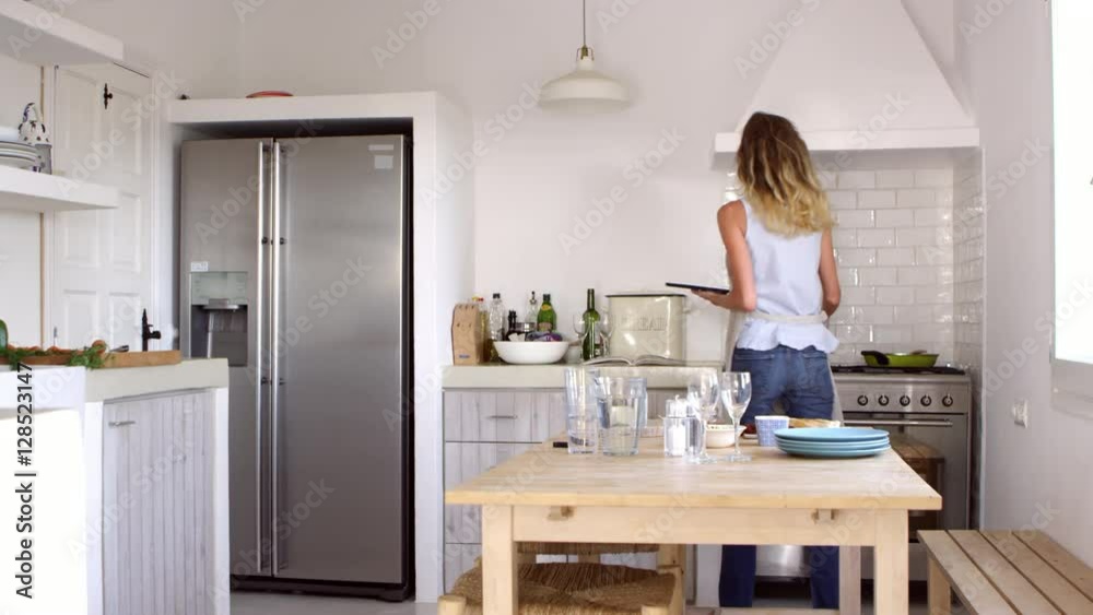 Woman finding recipe and preparing food, jump cut sequence shot on R3D Woman finding recipe and preparing food, jump cut sequence shot on R3D