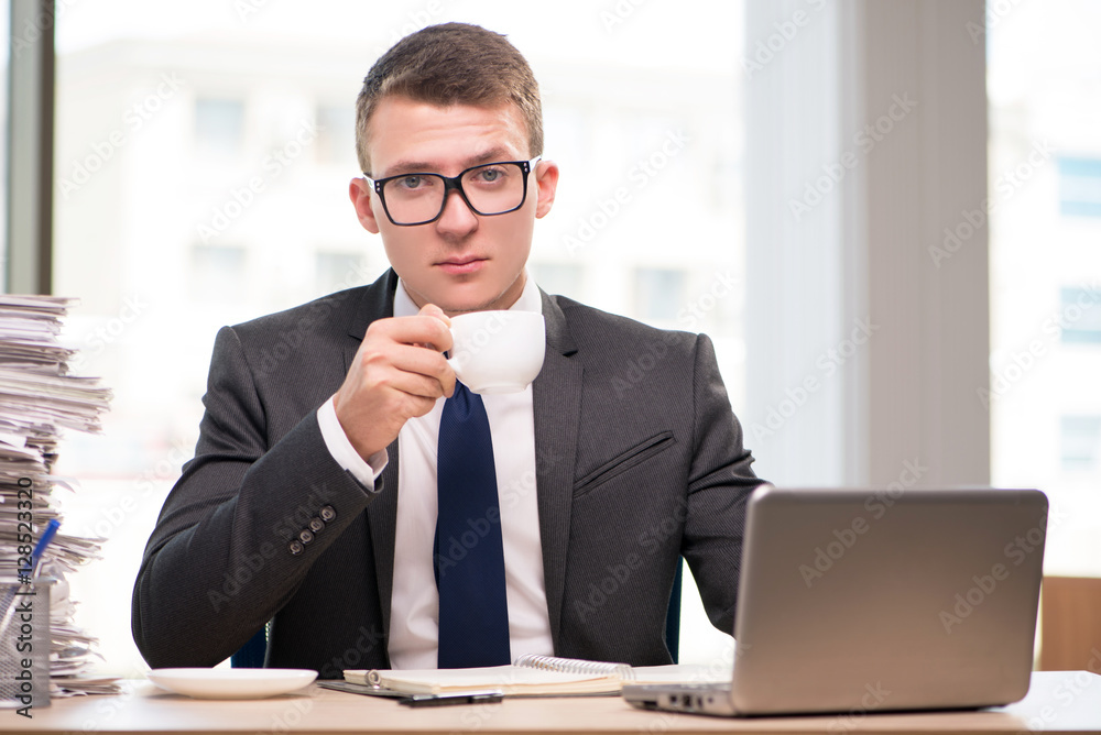 Young businessman drinking tea in the office Young businessman drinking tea in the office