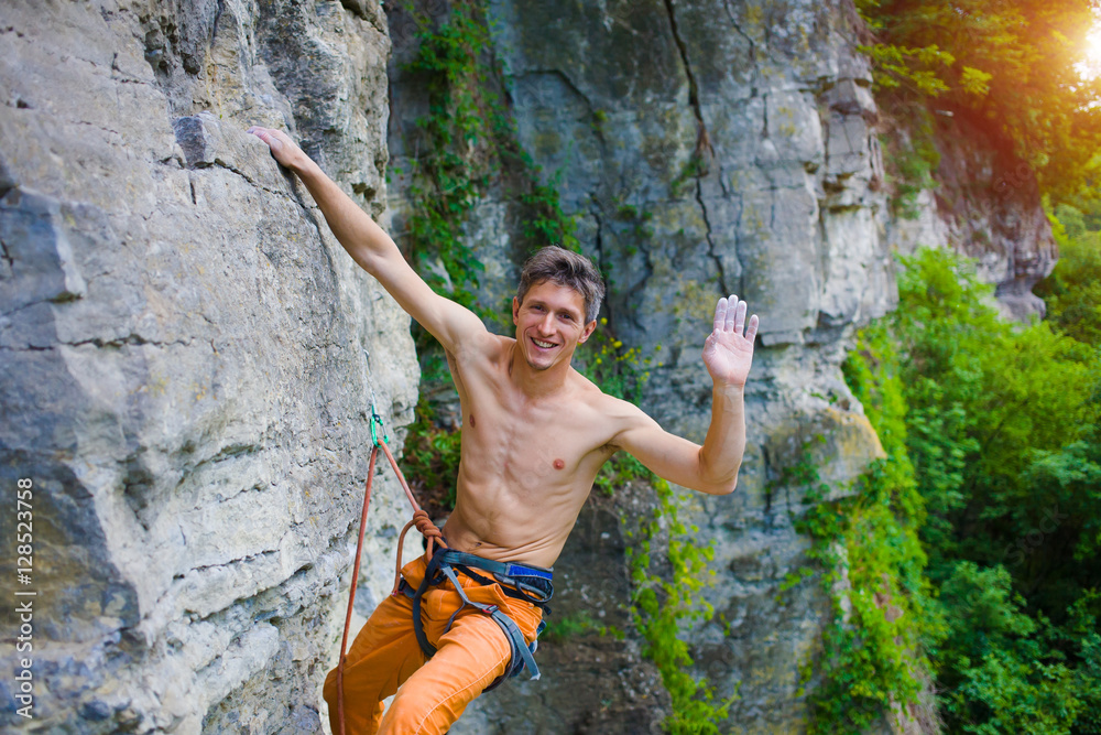 Climber climbs the rock.